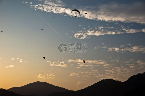 冒险行动风土耳其Fethiye附近的Oludeniz上方许多滑翔伞日落光辉图片