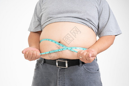暴饮食减肥高级的超重人用测量磁带他的脂肪腹部孤立在白色背景上健康医药和体重损失概念的保健医学和体重损失的概念背景图片