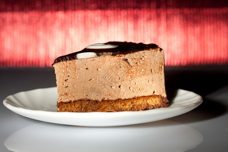 鲜红背景的美味巧克力蛋糕浅色焦点黑暗的美食可图片