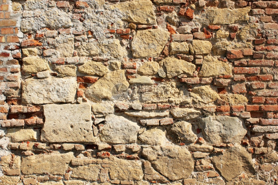 排材料具体的古老堡垒外墙用岩石和砖块纹理建造图片
