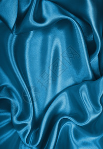 平滑优雅的蓝色丝绸或可用作背景质地装饰曲线图片