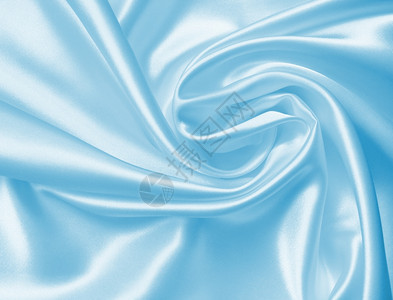平滑优雅的蓝色丝绸或可用作背景折痕纺织品叠图片