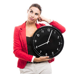 无聊的女商人手握着一个大钟表工作西班牙裔30多岁图片