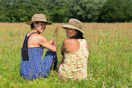 朋友们两个戴帽子的朋友回到盛开的草原喜悦绽放图片