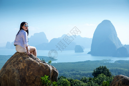 海成功坐在泰国SamedNangChee的PhangNgaBay山顶上的年轻女子图片