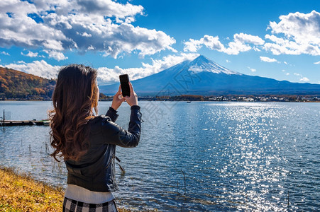 女使用手机在日本川口子湖藤山拍摄照片地点是富人山美丽的颜色移动图片