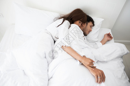 逃离丈夫卧室爱人躺在床铺幸福的上生活方式和笑女孩在白床上放松图片