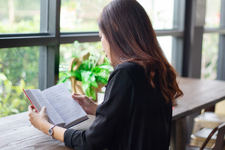 白色的教育亚裔妇女读一本放松时间的书长椅图片