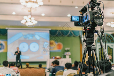 生产相机商业在会议室厅或研讨议活动和研讨会制作概念上播放屏幕摄影机的后边拍照片给亚洲演讲人的照片台上临时穿着便衣的亚洲演讲人现在图片