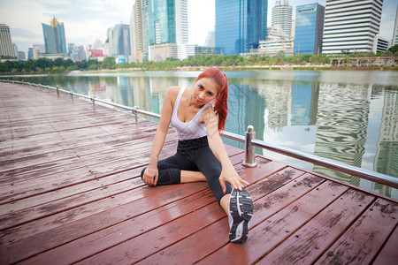腘绳肌拉伸运动型女员在市公园伸展腿部肌肉的锻炼图片
