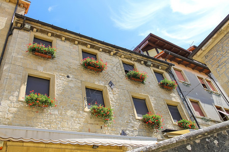 墙外部的玻璃在意大利城市的窗户上挂着鲜花的图片房屋图片