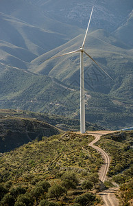 日落山丘中的风涡轮素环境绿色图片