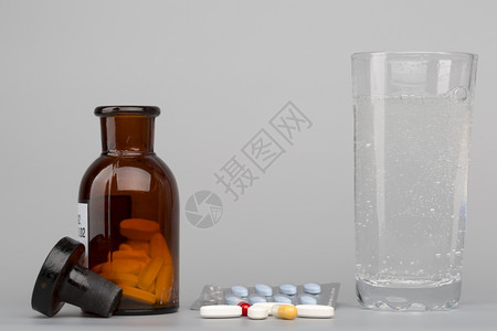 处方药剂师玻璃各种彩色药丸医瓶和水杯图片