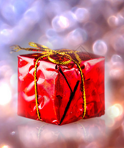 红色的派对闪亮礼物盒在彩色布基上圣诞节图片