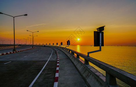 在泰国春布里日落时用街灯和橙色天空绕过沿海公路以街道灯和橙色天空包围沿海公路风景优美春武里图片