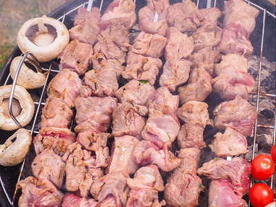 烤肉串黑圆木炭烧烤室外的黑圆形木炭烤肉贝图姆一顿饭图片