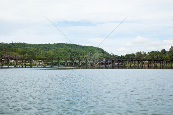 木头建造横跨河流的木环桥背面和河两边的山峰流动图片