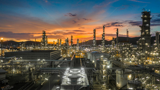 在职的产品力量以储油罐和石化工厂为业背景的炼油厂在黄昏空中观视石油和天然气炼厂在黄昏图片