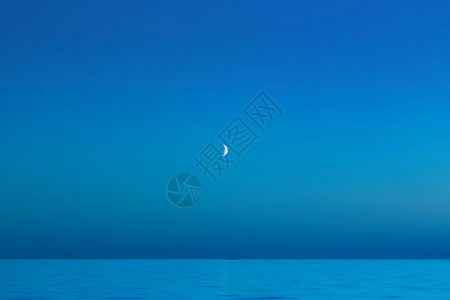 晚上月光海滩无云军蓝天面上有新月亮美丽夜海景的模糊背与20年空间Trindy颜色复制经典蓝色背景图片