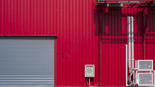 使用Hvac空气通风系统在工业建筑的红色铝墙上铺有管道并配Hvac空气通风系统的滚开门外部暖通空调理图片