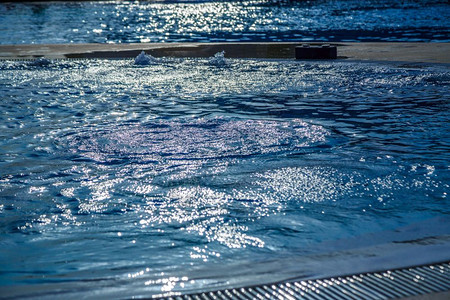 游泳池中的水与阳光在炎热的夏日闪耀加勒比海涟漪闪光图片