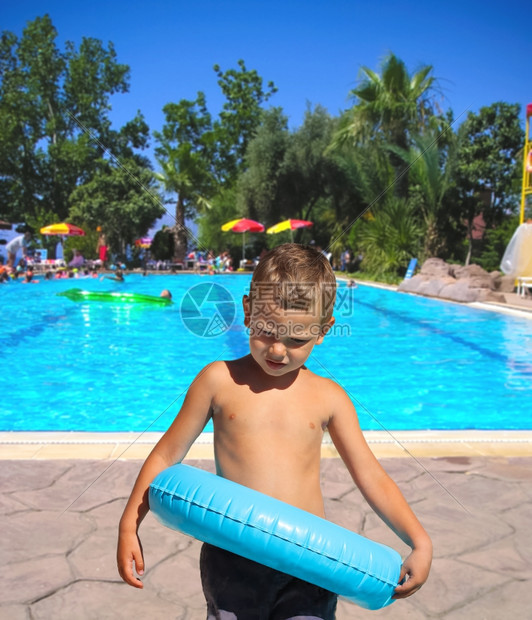 夏天假期严重的孩子站在游泳池附近温泉度假村热带图片