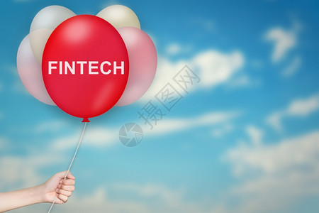货币电子的战略持有fintech或金融技术的手持Findtech或金融技术气球天空背景模糊图片