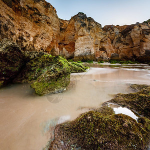海岸线卵石葡萄牙阿尔加维拉各斯波图德莫海滩的绿石金图片