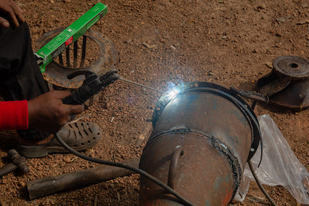 手动的泰格男人焊接机正在施工地焊接金属管道图片