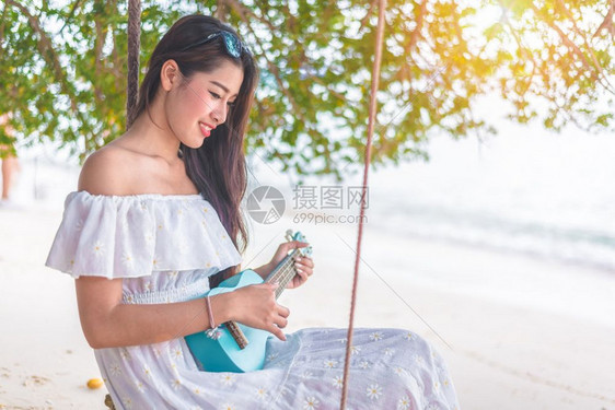 与Ukulele一起玩耍的美丽亚洲年轻女在海滩上放松人民与假日概念度和幸福生活概念夏天与海滩主题淑女支撑微笑图片