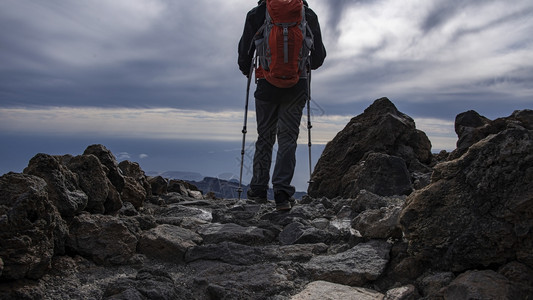 装备齐全的徒步在岩石山路上行走徒步旅积极的自由图片