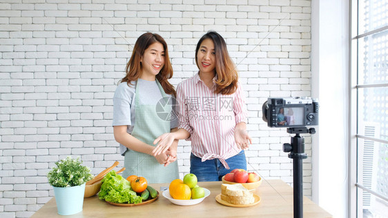 新鲜两位年轻的青女食物博客在录制视频时交谈与快乐刻vlog概念人与科技通讯等工作流图片