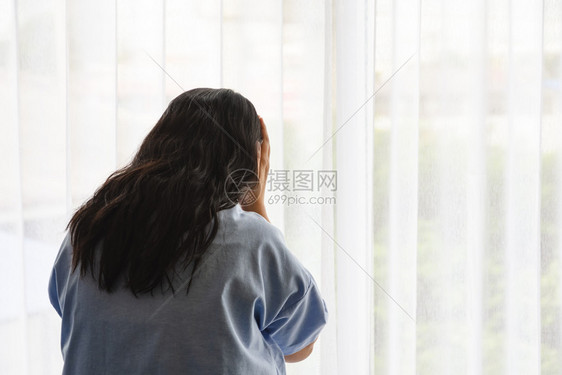 亚洲女患者在病人房医疗保险概念中对其疾病的痛苦和压力反视观点亚洲女患者疼痛和压力窗户坐着白种人图片