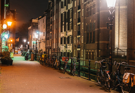 老的区夜间舒适阿姆斯特丹街道有自行车泊和温暖灯光建筑学图片