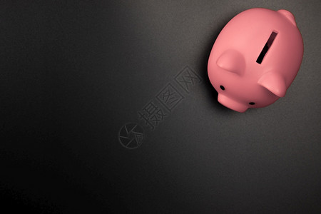 残酷的黑色背景顶视图上的粉色小猪银行带有复制空间储蓄财务和商业概念空间用于文本的黑色背景顶视图上的粉色小猪银行带有复制空间储蓄财图片