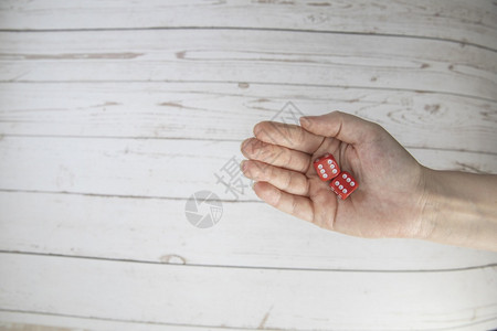 赌注白色的男人女手握白色背景上的红游戏骰子双六概念具有游戏板角色扮演游戏风险机会好运或的复制空间色调图像顶视文本的特写空间女手握图片