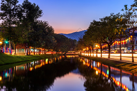 夜晚清迈门老城古墙和泰国清迈晚间护航道街上的光线小径旅游堡垒背景图片