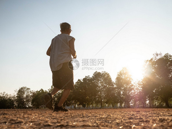 亚洲高年长男子在日落天空背景的公园里慢跑健康生活方式和保健概念亚洲人高级的草图片