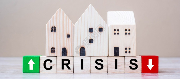 经济的CRISIS立方块在表底背景上采用木制房屋模型Corona大流行跌落商业失经济衰退开发者不动产和财概念家钱图片