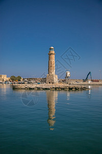 建筑学自然Rethymno市的灯塔和位于克里特黑洞有船对海浪反射云端港和雷瑟姆诺市的灯塔在克里特黑洞优质的图片