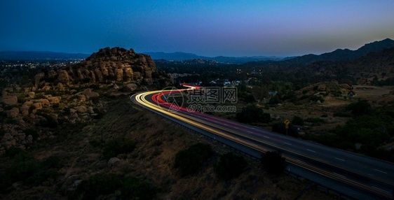 建筑学夜间被岩石包围的高速公路上黄灯和红的高角度拍摄夜间被岩石包围的高速公路上黄红灯高角度拍摄一种摩天大楼图片