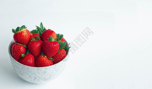 维查萨尔白色的大理石瓷碗白色背景有复制空间用绿色的叶头在白大理石杯中新鲜草莓生的图片