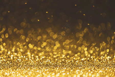 金色闪光灯背景散焦抽象烁和亮的星圣诞和新年派对概念背景特写星尘喜庆的金光闪微图片