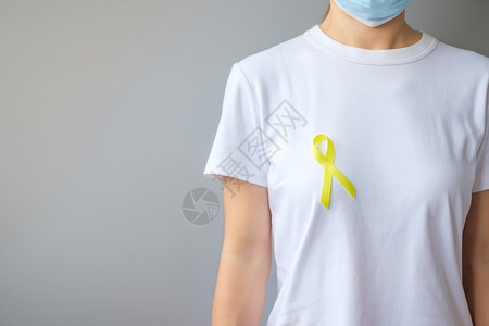 佩戴黄丝带预防癌症概念图片