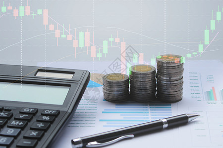 报告商业计算器硬币财务图表和办公桌纸笔背景股票图的双重以及市场生长图片
