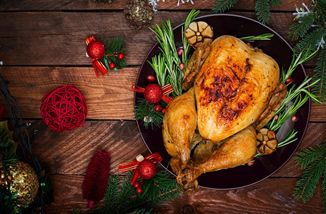 箔圣诞餐桌配有火鸡装饰着明亮的锡轮和蜡烛炸鸡吃圣诞晚饭平面露天风景美味的晚餐图片