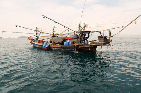 场景钓鱼黄昏时分在安达曼海的一条古老巴马尔传统渔船夫图片