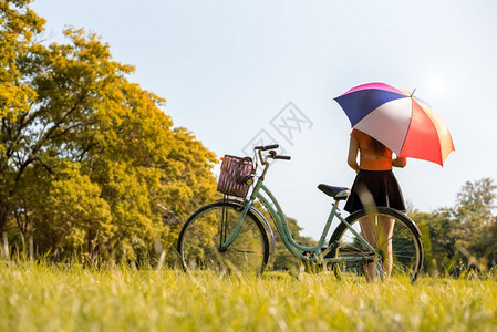 秋天草原上骑自行车的女性图片