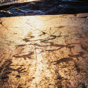 老的日落时欧尼加花形体碎裂在花岗岩板上雕刻史前石的物体时代506年俄罗斯卡雷利亚贝索夫诺斯角本国的原始图片