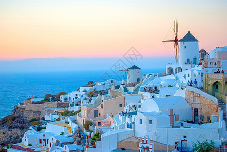 白色风车浪漫的采取景观OiaSantorini希腊以浪漫和美丽的日落闻名背景